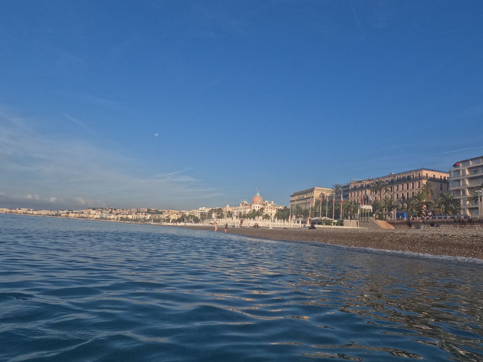 Nice from the water — the seafront, the Hotel Negresco dome, early morning blue sea